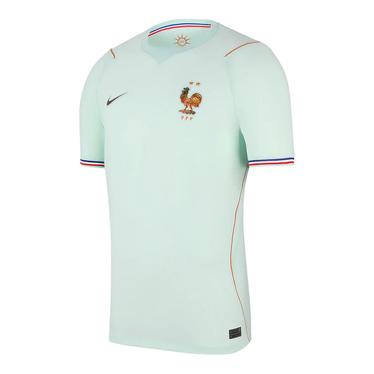 GOATkitz light mint green France 2026 adult away jersey with navy and red striped cuffs and copper trim.