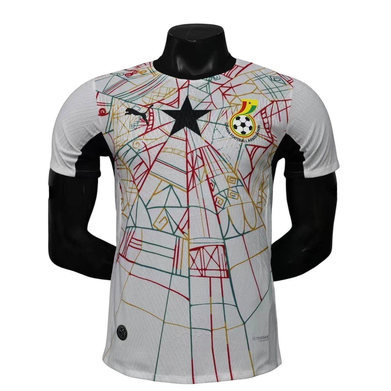 GOATkitz Ghana 2026 player version white football jersey with black accents and a red, yellow, and green geometric pattern. Features Ghana Football Association crest and Puma logo.