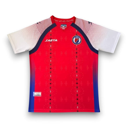 GOATkitz Haiti 2026 Third Jersey, red with white sleeves and blue accents. Features customisable name/number and badges.