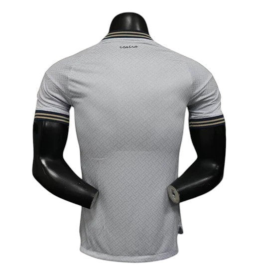 GOATkitz Italy 2026 player version away jersey in light grey with subtle geometric pattern and striped cuffs.