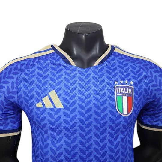 GOATkitz Italy 2026 player version home jersey in blue with a leaf pattern, gold Adidas logo, and Italia crest.