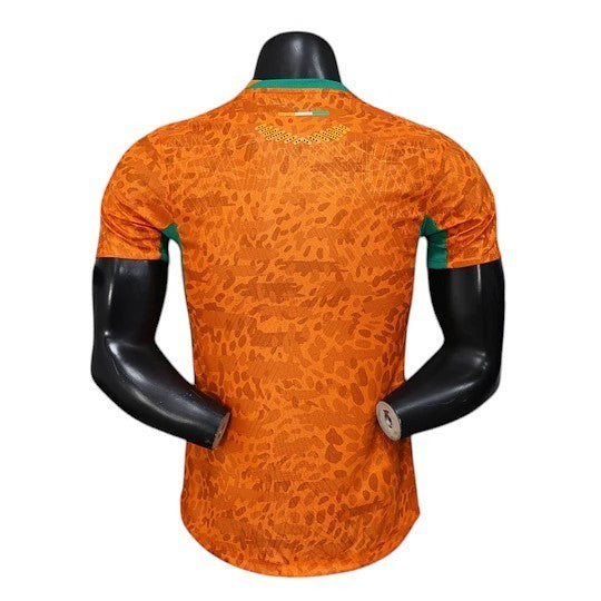 GOATkitz Ivory Coast 2026 player version home jersey, orange with green accents and a subtle camouflage pattern.