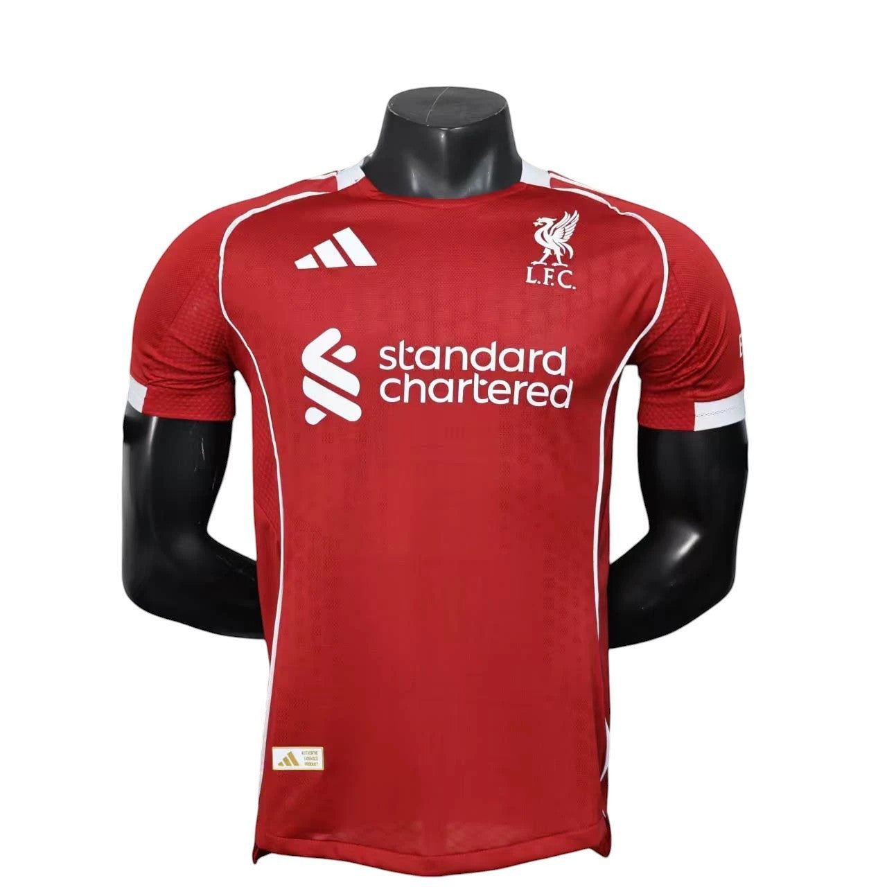 GOATkitz Liverpool 2025-26 Adult Player Version Home Jersey in red with white accents and Standard Chartered logo.