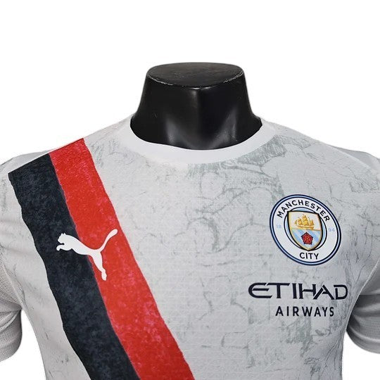 GOATkitz Manchester City x KidSuper 2025-26 player version jersey in gray with red and black stripe detail. Features Puma logo and customizable options.