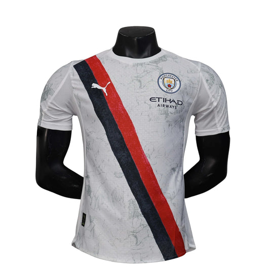 GOATkitz Manchester City x KidSuper 2025-26 player version jersey in gray with red and navy stripe detail. Customizable.