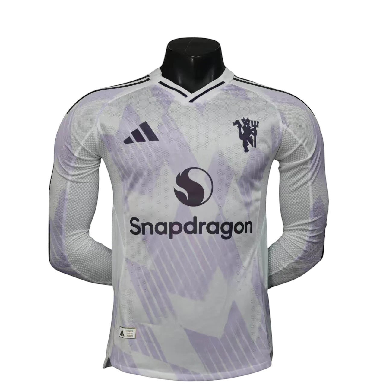 GOATkitz Manchester United 2025-26 white long sleeve player version away jersey with purple accents and Snapdragon logo.