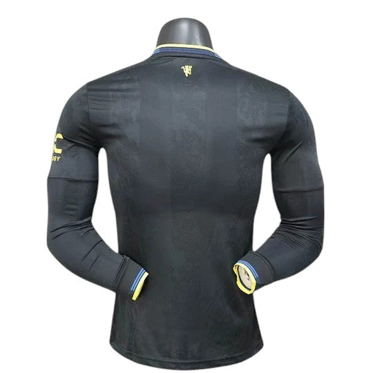 GOATkitz Manchester United 2025-26 black long sleeve player version jersey with yellow accents on cuffs and collar.