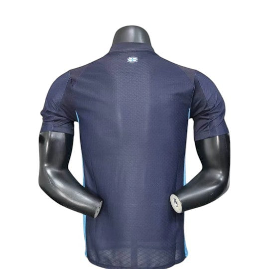 GOATkitz Olympique de Marseille 2025-26 player version away jersey, dark blue with light blue side panels and a subtle textured pattern.