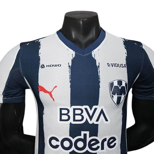 GOATkitz Monterrey 2025-26 player version home jersey, white with navy blue vertical stripes, V-neck, Puma logo, BBVA and codere sponsors.