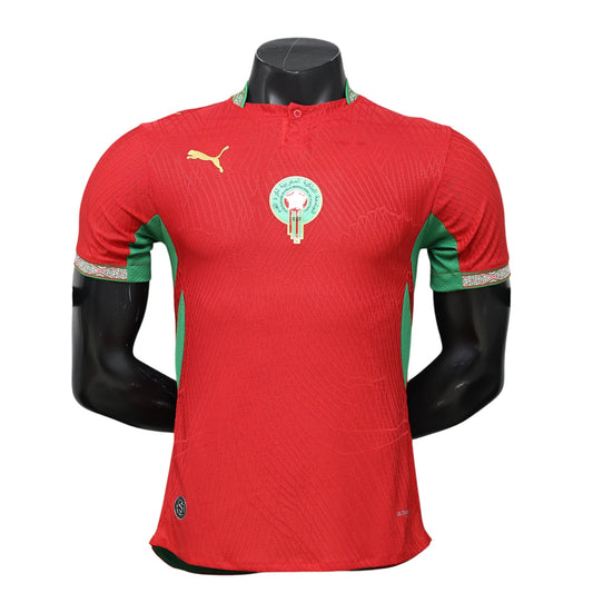 GOATkitz Morocco 2026 player version home jersey in red with green accents and crest. Short sleeves, button collar.
