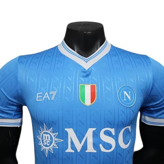GOATkitz Napoli 2025-26 adult player version home jersey in light blue with white trim, featuring team crest and sponsor logos.