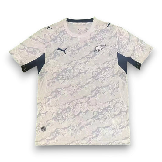 GOATkitz New Zealand 2026 adult home jersey, white with black accents and a swirling wave pattern. Features Puma logo and silver fern emblem.