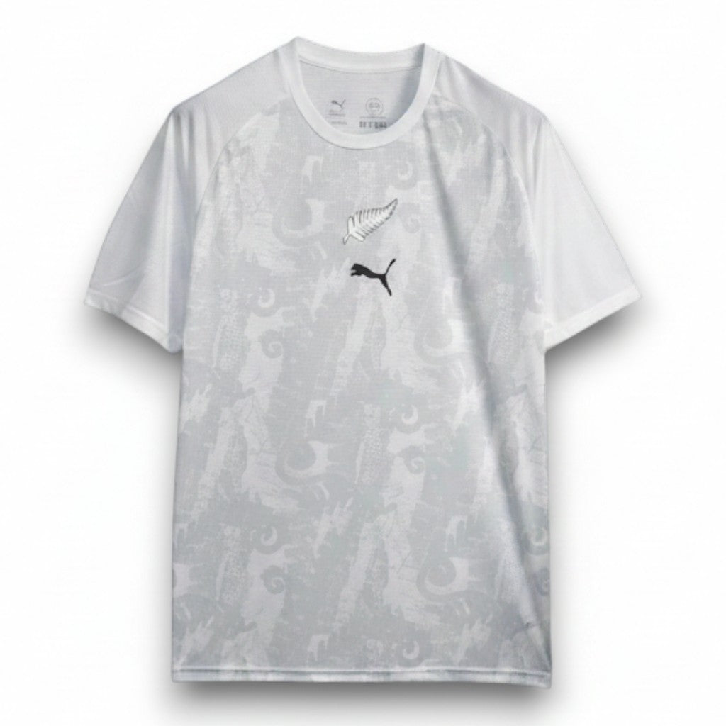 GOATkitz white New Zealand 2026 training jersey with black fern and Puma logo. Features a subtle grey dragon pattern.