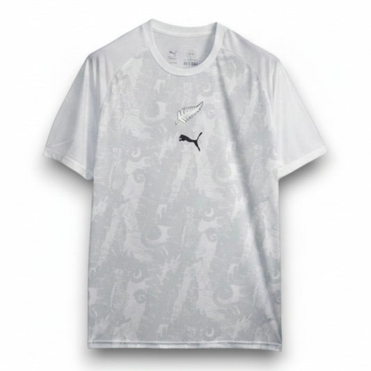 GOATkitz white New Zealand 2026 training jersey with black fern and Puma logo. Features a subtle grey dragon pattern.