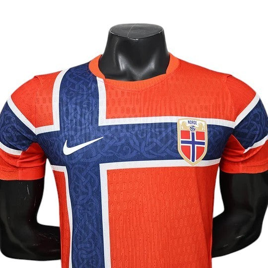GOATkitz Norway 2026 player version home jersey in orange with blue and white cross design. Features Nike logo and customizable crest.