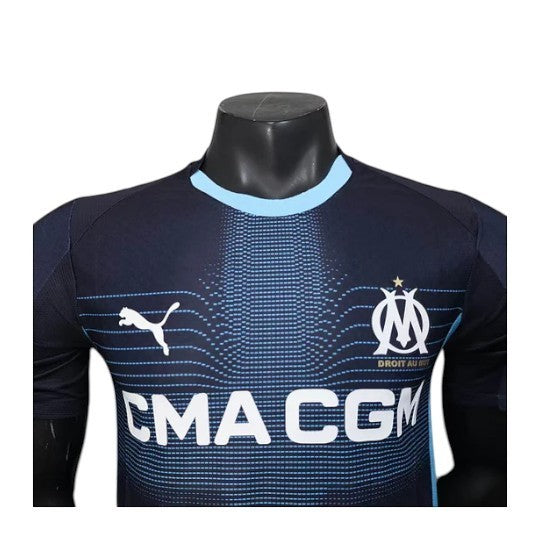 GOATkitz Olympique de Marseille 2025-26 player version away jersey in navy blue with light blue accents. Features CMA CGM sponsor.