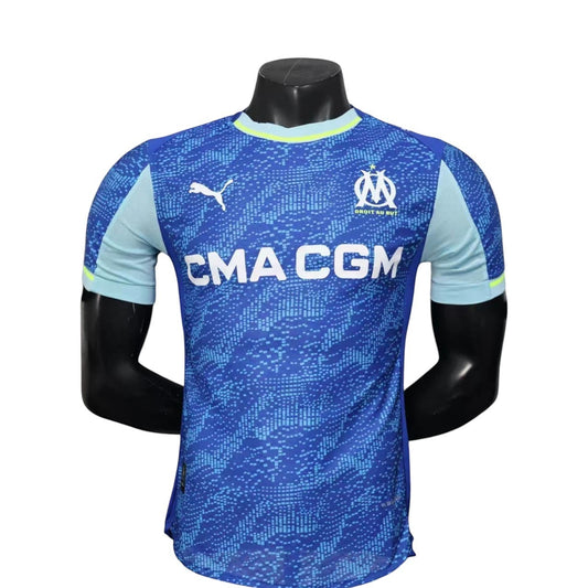 GOATkitz Olympique de Marseille 2025-26 player version third jersey in blue with CMA CGM logo. Features light blue accents and a pixelated pattern.
