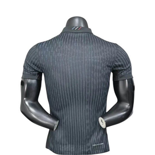 GOATkitz PSG 2025-26 Player Version Jordan 4th Jersey, black with vertical stripe pattern and subtle collar detail.