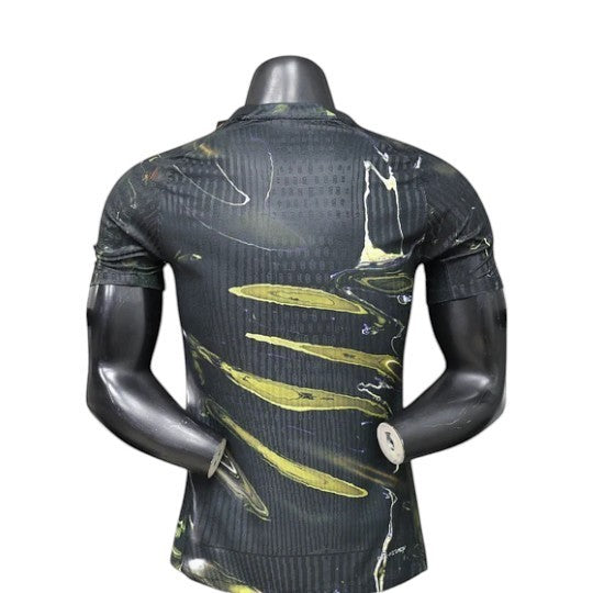 GOATkitz PSG 2025-26 player version jersey with a black and yellow swirl pattern and vertical stripes.