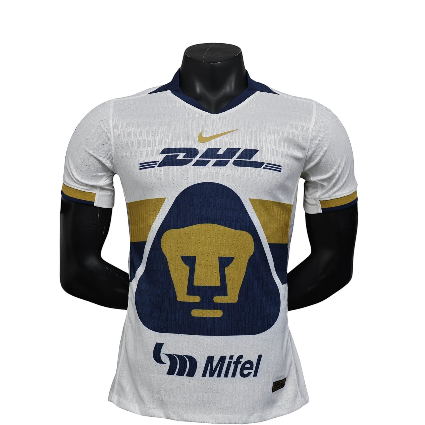GOATkitz Pumas UNAM 2025-26 player version white football jersey with navy and gold accents, DHL logo, and Pumas crest.