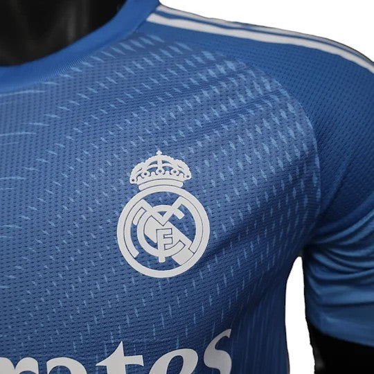 GOATkitz Real Madrid 2025-26 blue goalkeeper player version jersey with white crest and stripes. Lightweight, breathable fabric.
