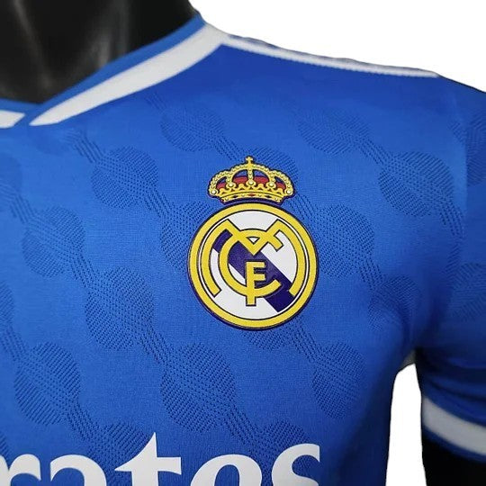 GOATkitz Real Madrid 2025-26 blue long sleeve player version jersey with embroidered crest. Customizable.