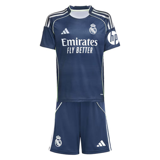 GOATkitz Real Madrid 2025-26 kids away jersey and shorts set in navy blue with white and lime green accents. Features club crest, Adidas logo, and sponsor logos.