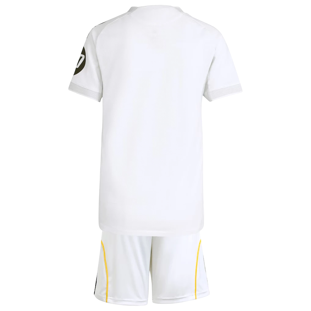 GOATkitz Real Madrid 2025-26 kids home jersey and shorts set, white with gold trim and black number 7 on sleeve.