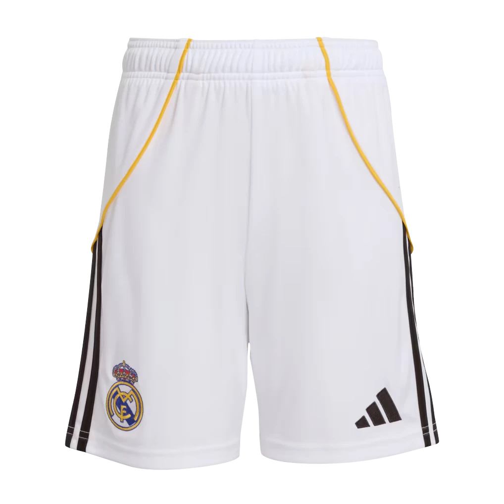 GOATkitz Real Madrid 2025-26 kids white football shorts with yellow trim and black stripes. Features club crest and Adidas logo.