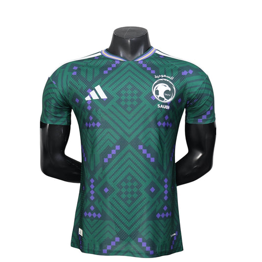 GOATkitz Saudi Arabia 2026 player version home jersey in green with purple geometric pattern and white Adidas logo.