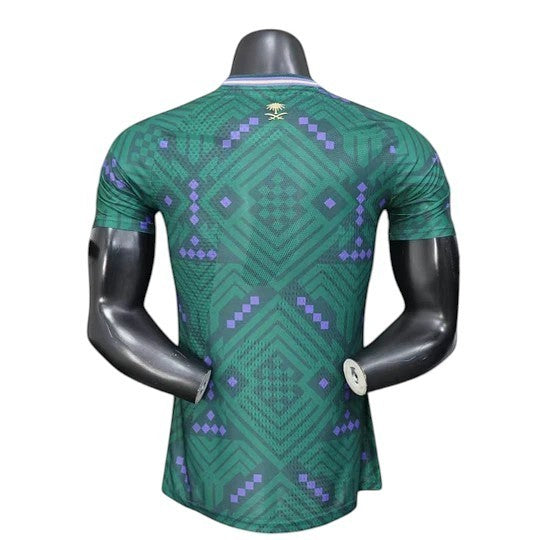 GOATkitz Saudi Arabia 2026 player version home jersey in green with purple geometric pattern and palm tree emblem.