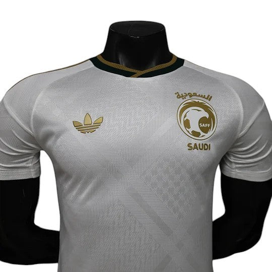 GOATkitz Saudi Arabia 2026 player version away jersey in white with gold Adidas logo and Saudi emblem. Features a subtle geometric pattern.
