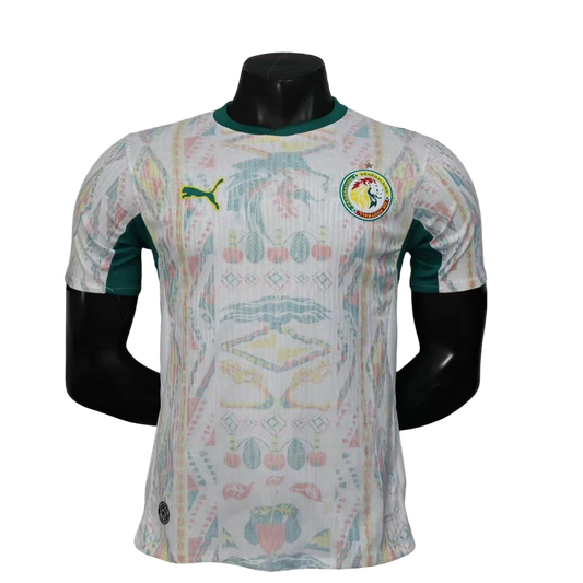 GOATkitz Senegal 2026 player version home jersey in white with green accents and a colourful abstract pattern. Features Puma logo and Senegal crest.
