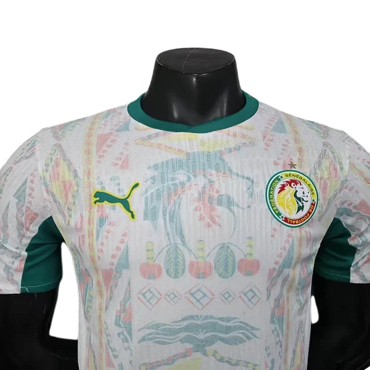 GOATkitz Senegal 2026 player version home jersey in white with green accents and a vibrant all-over pattern. Features Puma logo and Senegal crest.