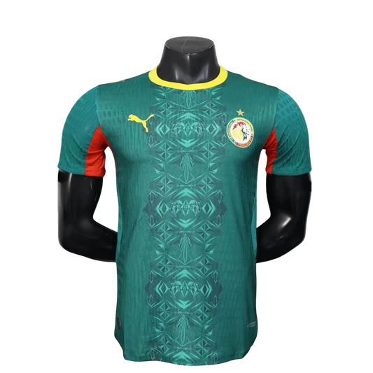 GOATkitz Senegal 2026 player version away jersey in green with yellow trim and red accents. Features a geometric pattern and team crest.