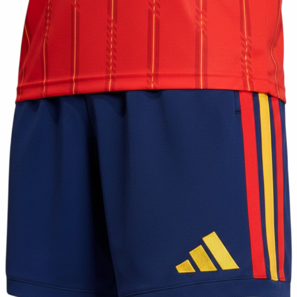 GOATkitz Spain 2026 kids home jersey and shorts set in navy blue with red and yellow stripes.