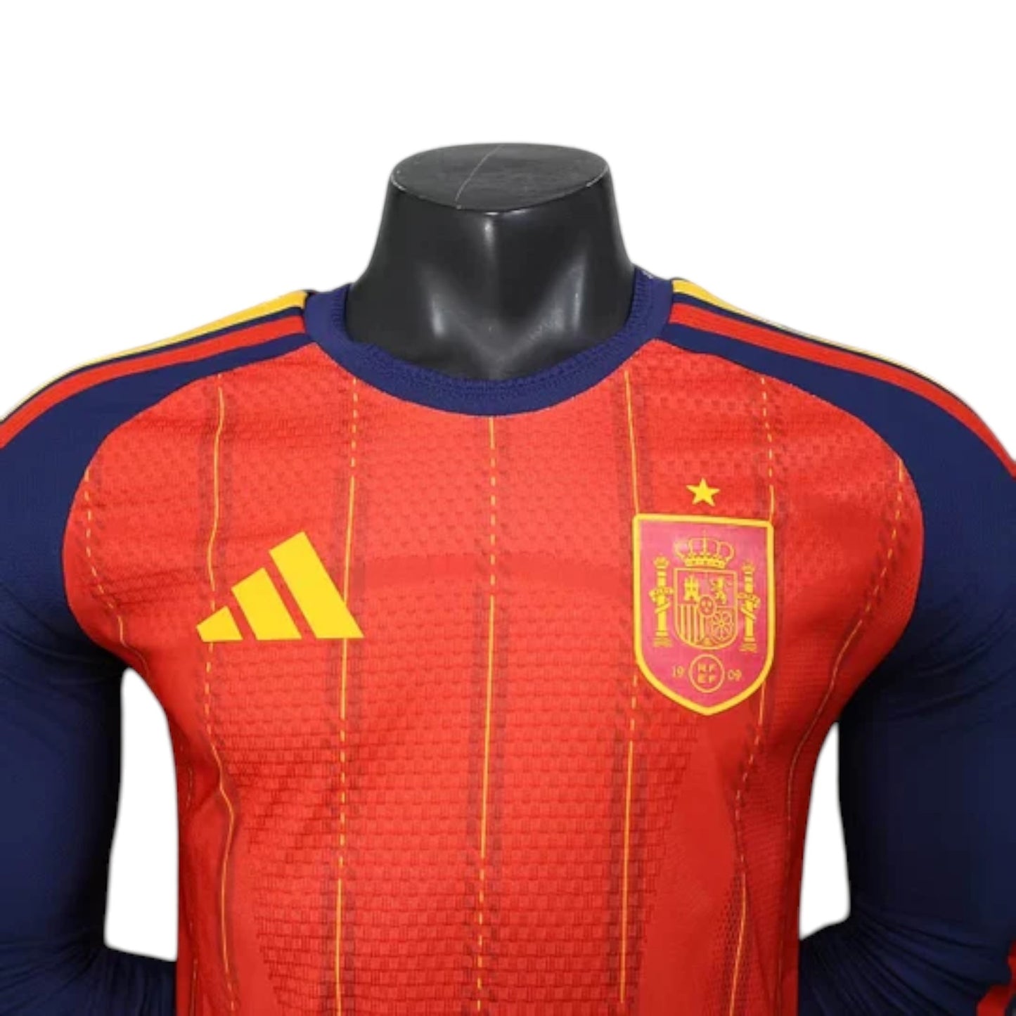 GOATkitz Spain 2026 long sleeve player version home jersey in red with navy blue sleeves and yellow accents. Features crest and Adidas logo.