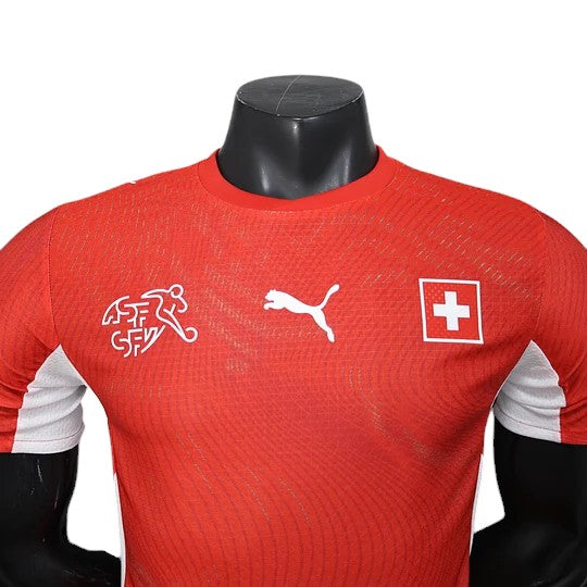 GOATkitz Switzerland 2026 player version home jersey in red with white accents. Features Puma logo and Swiss Football Association crest.