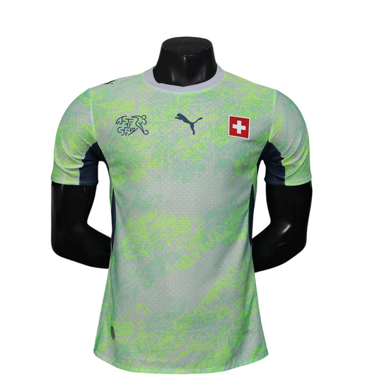 GOATkitz Switzerland 2026 player version away jersey in light green with abstract pattern and navy blue accents. Features Puma logo and Swiss flag.