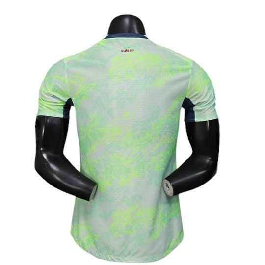 GOATkitz Switzerland 2026 player version away jersey in light green with a subtle abstract pattern and navy blue accents on the sides.