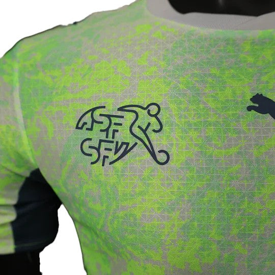 GOATkitz Switzerland 2026 player version away jersey in neon green with grey abstract pattern and navy logo.