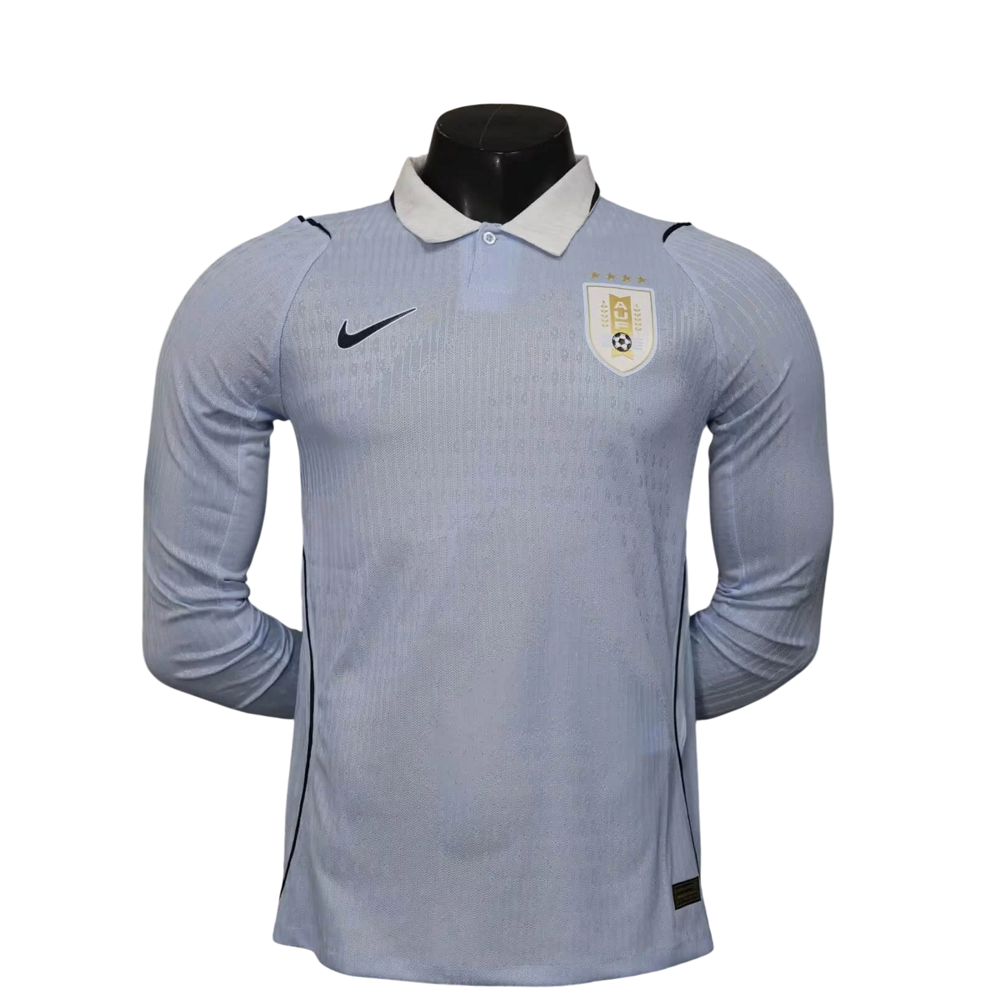 GOATkitz light blue Uruguay 2026 long sleeve player version soccer jersey with white collar and gold crest.
