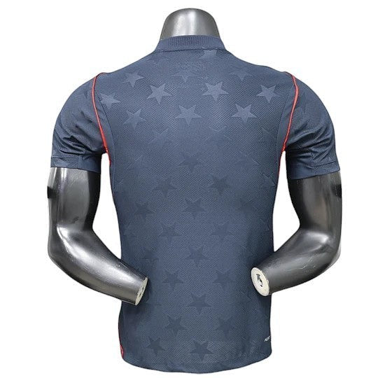 GOATkitz navy blue USA 2026 player version away jersey with embossed stars and red trim on sleeves.