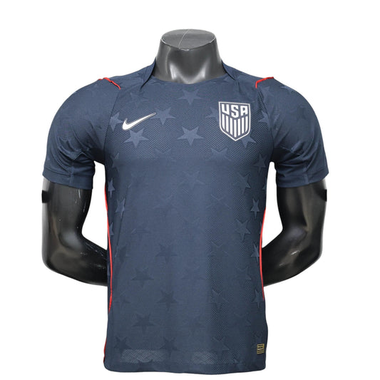 GOATkitz navy blue USA 2026 player version away jersey with subtle star pattern and red trim. Customizable.