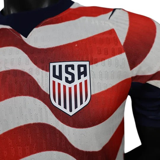 GOATkitz USA 2026 Player Version Home Jersey with red and white stripes and USA crest. Navy blue collar and sleeve trim.
