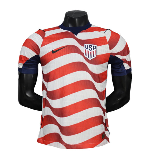 GOATkitz USA 2026 player version home jersey with red and white wavy stripes, navy collar and sleeves, and USA crest.