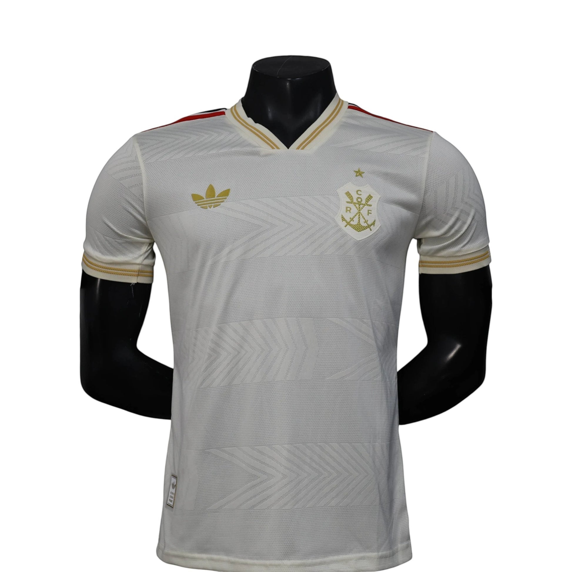 GOATkitz white Adidas soccer jersey with gold trim and crest, featuring a subtle chevron pattern. Player version, customizable.